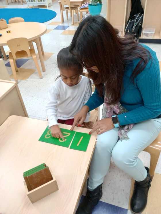 Guide working with an elementary student.