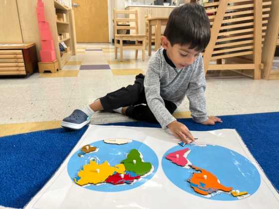 Kindergarten student working on a puzzle.